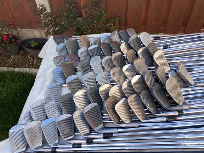 A selection of golf clubs and bags. All right handed clubs.