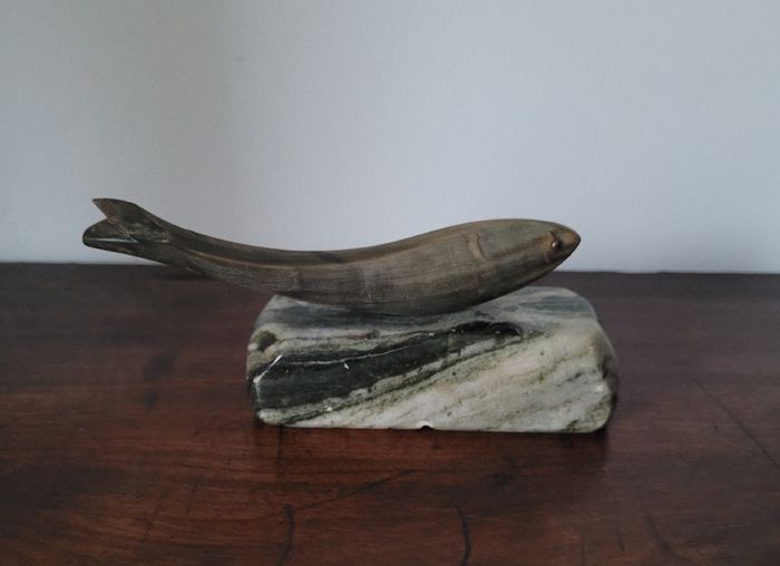 Vintage fish sculpture on marble