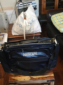 Nescafe shoulder cross bag. Travelling bag with suit case.