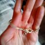 Silver toned bracelet with a heart shaped charm Image 5