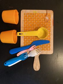 toy wooden chopping board, cutlery, cups