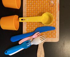 toy wooden chopping board, cutlery, cups