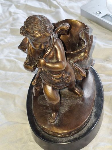 Bronzed Winged Cherub putto open seashell or leaf-shaped vessel with a scorpion like tail.