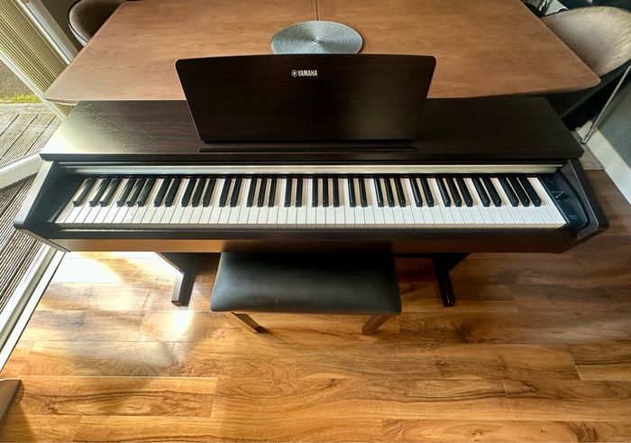 Yamaha Arius YDP-142 Digital Piano with rosewood finish and matching stool