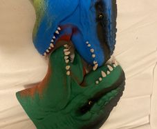 Two dinosaur head mittens