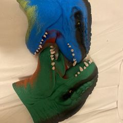 Two dinosaur head mittens