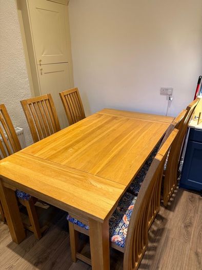 Solid oak dining table & 6 reupholstered dining chairs