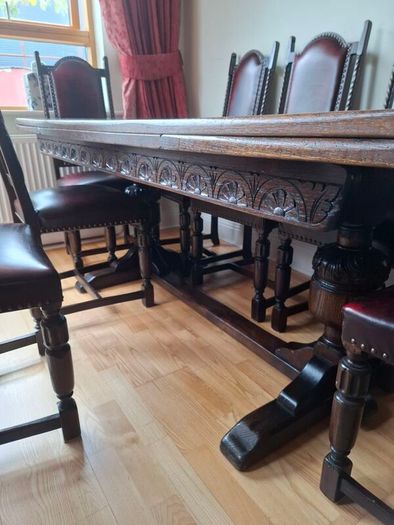 Dark Oak Dining room table and 8 leather chairs.