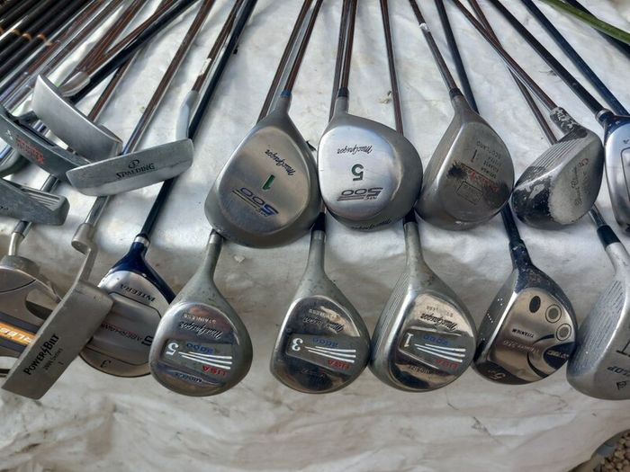 A selection of Golf clubs. Bags and golf balls.