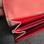 Michael Kors red and pink wallet with gold-tone MK logo. Multiple card slots and a zipped coin compartment. In perfect condition apart from some minor wear inside, which is not noticeable when using it, as shown in the photos. Image 6