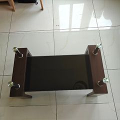 Glass coffee table with dark wood base
