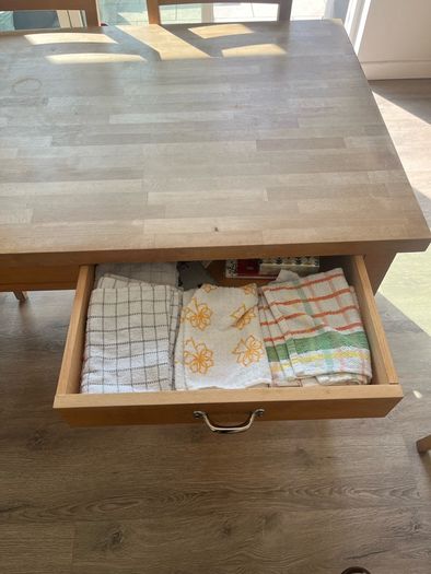 Solid oak dining table and 8 chairs with storage drawers