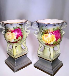Pair of antique ornate urns with roses