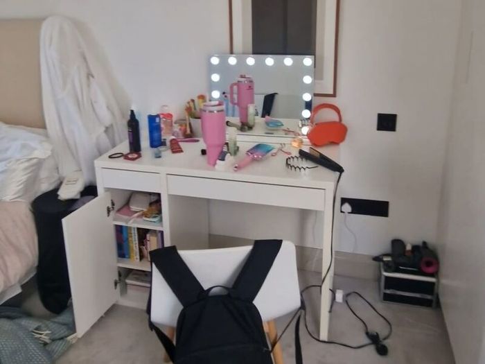 Double bed with mattress and table.