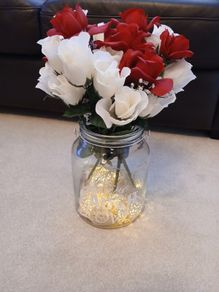 vase with artifical flowers and lights
