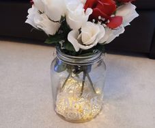 vase with artifical flowers and lights