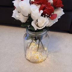 vase with artifical flowers and lights