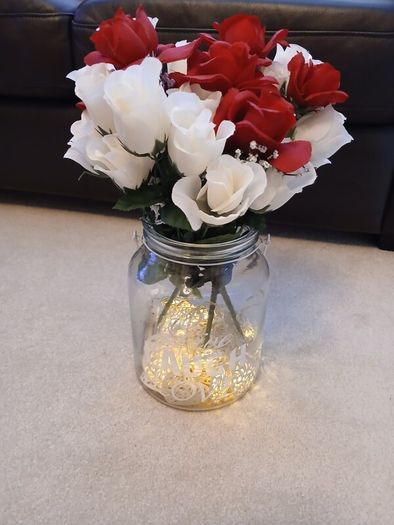 vase with artifical flowers and lights