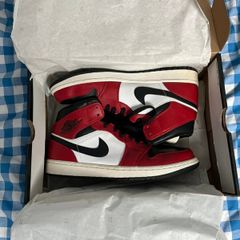 Nike Air Jordan 1 Mid "Chicago Black Toe" sneakers. The iconic black, white, and red colorway is inspired by the original 1985 "Chicago" release