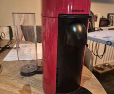 nespresso vertuo plus machine and coffee pods with holding tray