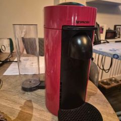 nespresso vertuo plus machine and coffee pods with holding tray