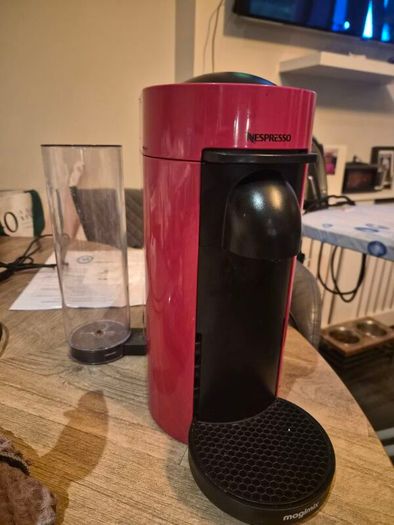 nespresso vertuo plus machine and coffee pods with holding tray