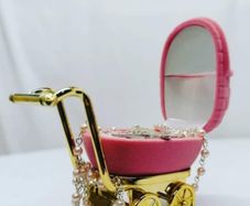 small pram with baby rosary beads