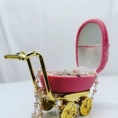 small pram with baby rosary beads