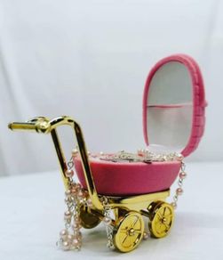 small pram with baby rosary beads