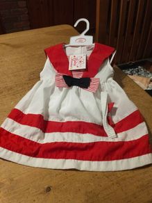 This is a Cutey Avenue brand 18-24 month red and white striped sailor-style dress. New with tags