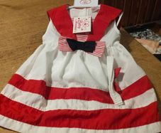 This is a Cutey Avenue brand 18-24 month red and white striped sailor-style dress. New with tags