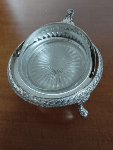 A vintage silver-plated butter dish or caviar bowl with a three-legged lid.
