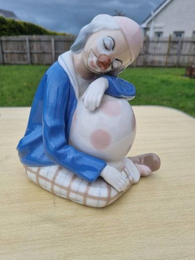 Porcelain sleeping clown with ball