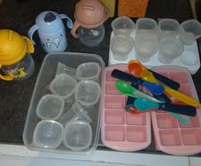 baby containers, spoons and bottles of water