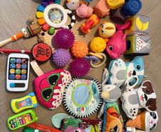 baby toy selection sensory balls, phones, teddies, soft books