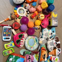 baby toy selection sensory balls, phones, teddies, soft books