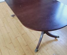 Mahogany dining table with fold-out leaf