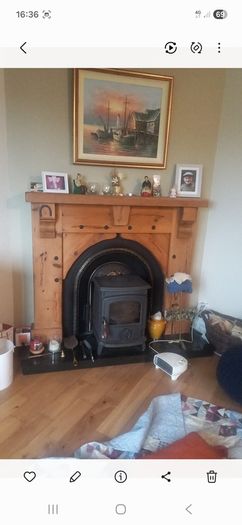 Timber surround with cast iron insert for fireplace