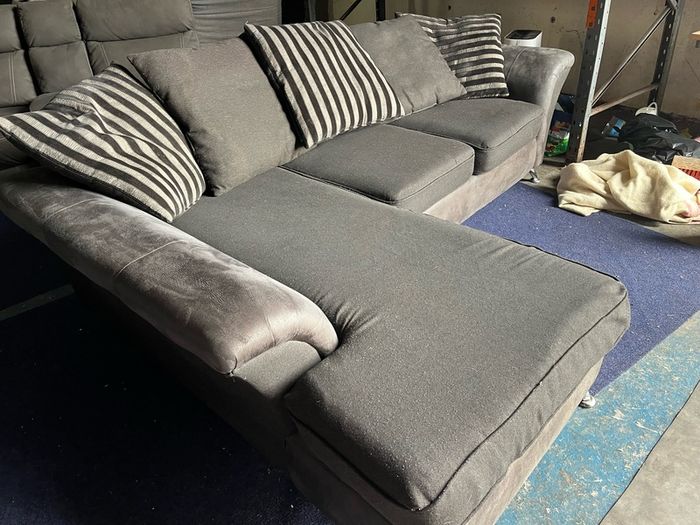 grey/black corner sofa with scatter cushions
