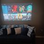 philips neopix ultra 2tv+ home projector and height adjustable stand, built in speakers and android TV with play store stand comes with power point bracket on it as seen in pictures also remote and phone holder Image 5