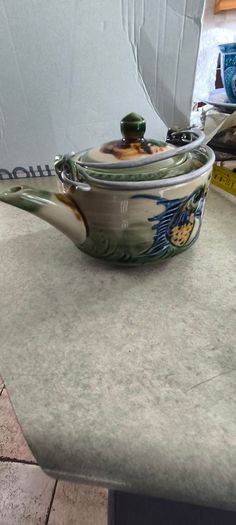 3 different items. No. 1- Mid-Century Porcelain Teapots, Japan, 1960.  95.00 euro. 2- VTG Hand Painted Le Poet Laval France Serving Plate 22.00 euro. 3- Vintage Short Dark Forest Green Ceramic 22.00 euro.