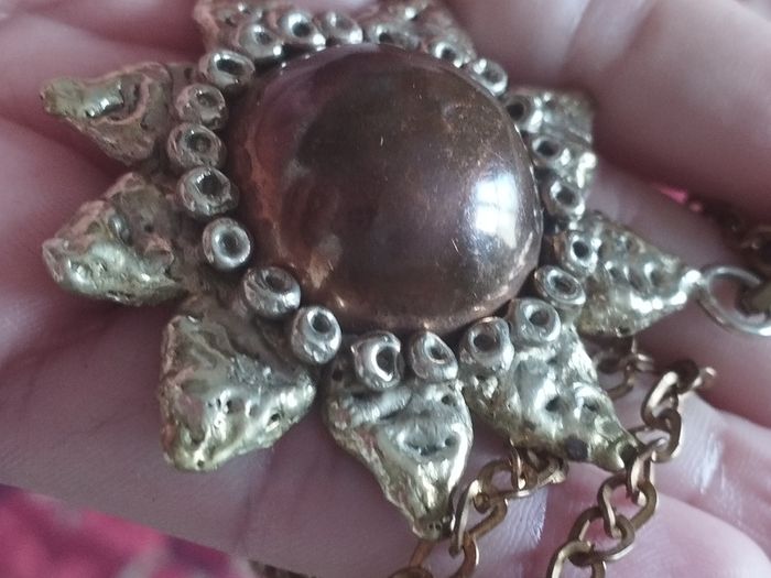 Vintage pendant on a long chain.