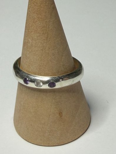 Handmade sterling silver ring with flush set stones. Size O