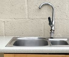 Kitchen sink with countertop and tap