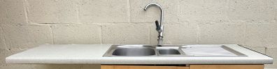 Kitchen sink with countertop and tap
