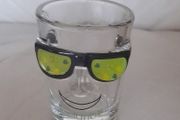 Shot glass, face with sun glasses and Ireland written on it