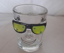 Shot glass, face with sun glasses and Ireland written on it