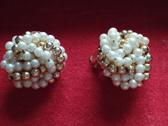 Vintage clip-on earrings with a cluster of faux pearls and gold-tone beads.