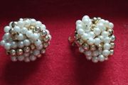 Vintage clip-on earrings with a cluster of faux pearls and gold-tone beads.