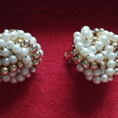 Vintage clip-on earrings with a cluster of faux pearls and gold-tone beads.